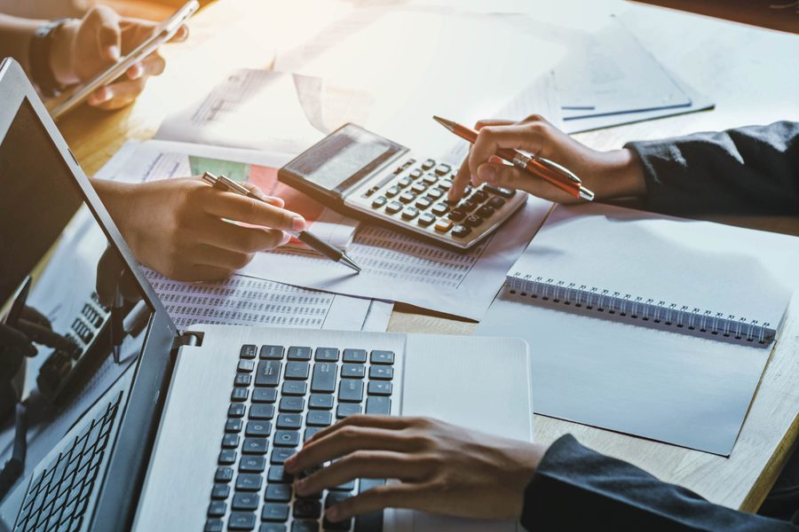 Advisors reviewing a client's portfolio numbers